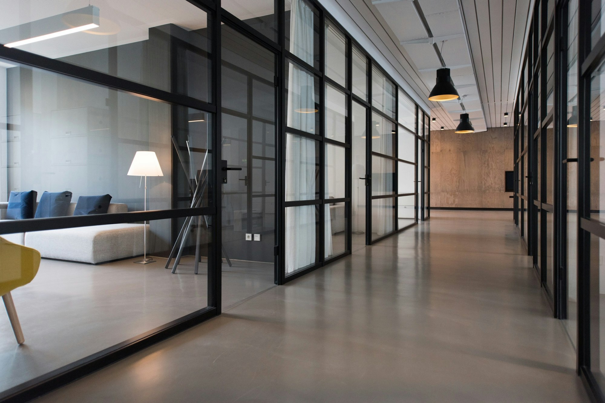 A glass-walled office corridor